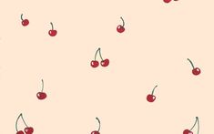 cherries on a pink background with green stems