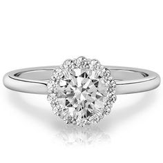 a white gold engagement ring with an oval diamond center