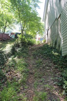 a dirt path going up the side of a house