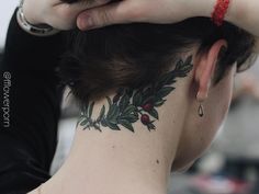 a woman with a tattoo on her neck is holding her hand to her head and looking at the camera