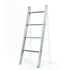 a ladder leaning up against a white wall