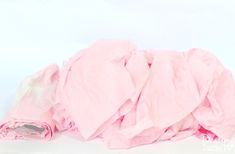 a pile of pink cloth sitting on top of a white table