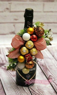 a bottle filled with chocolates and christmas decorations