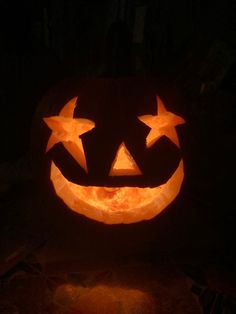 a pumpkin carved to look like a jack - o'- lantern in the dark