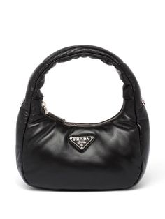 Find PRADA Padded Nappa Leather Mini Bag on Editorialist. This Prada mini bag is crafted from padded nappa leather and features a top zip fastening, a single top handle, an adjustable and detachable shoulder strap, and a main compartment. The bag has a silver-tone hardware and an enamel triangle logo. Prada Nappa Bag, Designer Mini Bags, Mini Prada Bag, Prada Black Bag, Designer Handbags Prada, Black Prada Bag, Prada Mini Bag, Mini Bag Black, Mini Hobo Bag