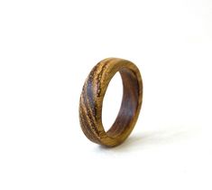 a wooden ring is shown against a white background with the wood inlayed to it