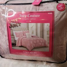 a pink bed set in a box on a white furnishing