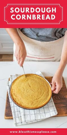 someone cutting up a cornbread on top of a wooden board with the words, sourdough cornbread