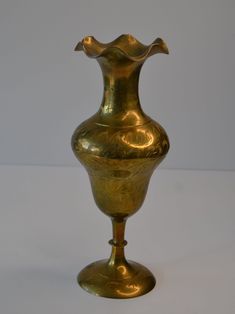 a gold vase sitting on top of a table