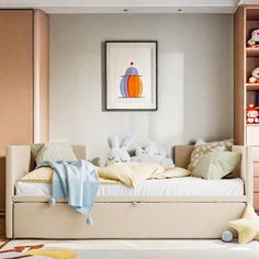 a child's bed with stuffed animals on it in a room that has wooden flooring and white walls