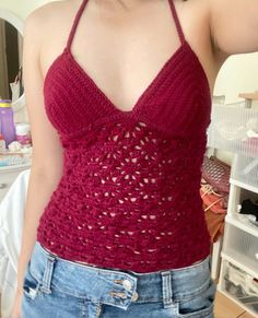 a woman wearing a red crochet tank top