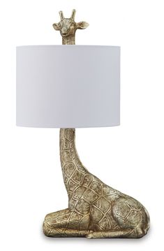 a giraffe lamp with a white shade on it's head and foot