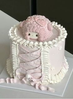 a cake decorated with pink and white icing