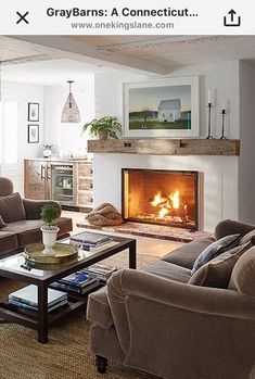 a living room with two couches and a fire place in the middle of it