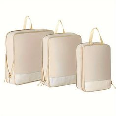 three bags with handles are lined up against each other, one is beige and the other is white