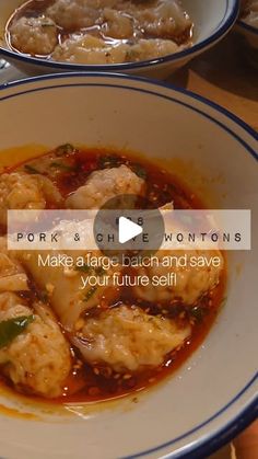 a bowl filled with dumplings and sauce on top of a table