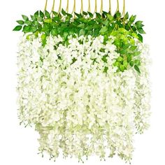 a bunch of white flowers hanging from a metal rod with green leaves on it's end