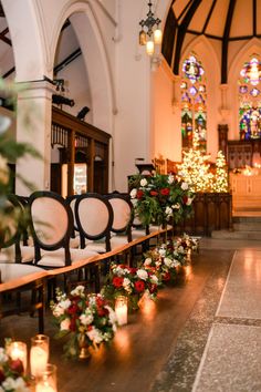 rows of chairs lined up with flowers and candles in front of the alter at a church