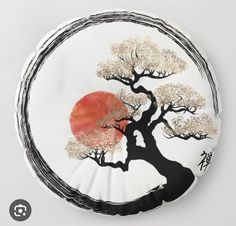 a round pillow with a painting of a tree on it