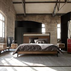 a large bed sitting in the middle of a bedroom next to two tables and chairs