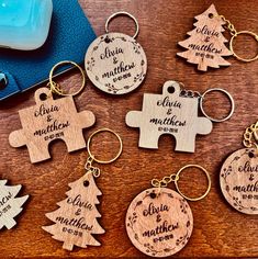 personalized wooden keychains with engraved names and christmas tree design on them, sitting on a table