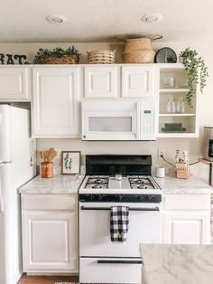 a white stove top oven sitting inside of a kitchen