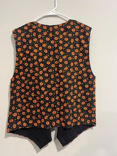 Halloween vest  Designer : Handmade  Measurements: Bust:21" Waist: 21" Length:24" Fitted Halloween Party Vest, Fitted Vest For Halloween Party, Halloween Festival Sleeveless Vest, Sleeveless Halloween Festival Vest, Sleeveless Vest For Halloween Festival, Black Vest For Halloween Costume, Fitted Orange Vest For Fall, Fitted Halloween Vest Top, Vintage Sleeveless Vest For Costume Party