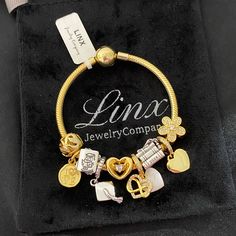 Linx Snake Chain Style Charm Bracelet With A Ball Clasp, Featuring Linx Logo. The Bracelet Comes With 9 Linx Charms As Shown. *All Items Are 925 Sterling, Silver And 14k Yellow Gold Over 925 Sterling Silver. *Linx Bracelets And Charms Are Very Well Made And Of Superior Quality, Designed To Last. These Pieces Come With A 100% Satisfaction Guarantee Or Your Money Back. *The Bracelet Is Available In Multiple Sizes *Additional Charms Can Also Be Added To The Bracelet And The Ones Included Are Remova White Gold Metal Charm Bracelet For Anniversary, Metal Jubilee Charm Bracelet For Anniversary, Silver Bracelets With Dangling Charms For Anniversary, Elegant Silver Chain Bracelet With Dangling Charms, Linx Bracelets, 2024 Graduation, Class Of 2024, Yellow Gold Bracelet, Jewelry Pouch