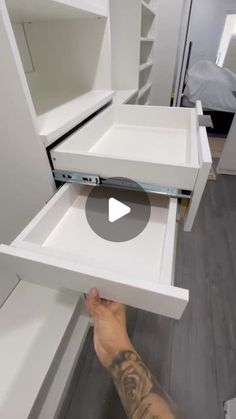 a man is holding the drawer open to show what's inside