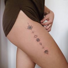 a woman's thigh with the word love written in small stars and hearts on it