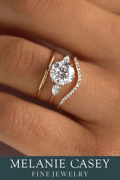 a woman's hand with a diamond ring on her finger and the words melanie casey fine jewelry