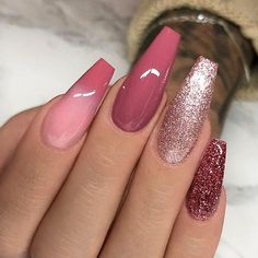 a woman's hand with pink and gold nail polishes on her nails, while she