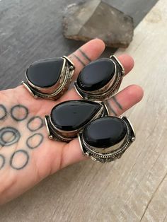 -----Price per Item----- Unique big statement rings, made with alloy metal and big Black Onyx stones. Each ring has a unique stone, so you can see there is a number that represents each ring for you to choose the one you like best. They are size adjustable, size 9 being the smallest size available, the bigger size you adjust it to, they might be a gap in the back of the ring. A most have addition to your everyday ring collection. Ring #1, #2, #3,#6 ,#7,#9, #10,#11, #14 - 1.75 inch long Ring #4, Ring Black Stone, Big Statement Rings, Dope Jewelry Accessories, Big Stone Ring, Fall Rings, Estilo Hippy, Black Stone Ring, Big Ring, Bohemian Ring