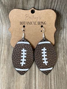 With fall comes football season!  show your love for football with these adorable football earrings!  They are made with faux leather and detailed with white HTV.  They are lightweight but sturdy.  They are made to order so please allow a few days for production before being shipped. Please note that I do not accept returns as my items are made to order. Additionally, due to sanitary reasons with piercing jewelry, returns are not accepted. However, if you encounter any issues with your order, pl Football Earrings, Football Season, Piercing Jewelry, Jewelry Earrings Dangle, Dangle Drop Earrings, Dangle Earrings, Accessory Gift, Faux Leather, Jewelry Earrings