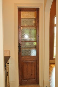 an image of a wooden door in the middle of a room with glass on it