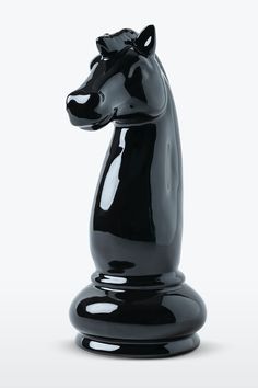 a black chess piece is shown on a white background