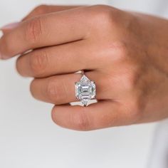 a woman's hand with a diamond ring on it