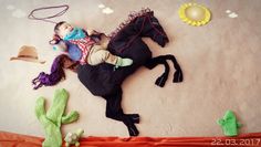 a child laying on top of a stuffed horse next to other toy animals and toys