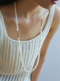 This elegant necklace showcases simplicity at its finest, featuring smooth white shell beads delicately strung together. The minimalist design exudes a timeless charm, perfect for both casual and formal occasions. With its versatile style, this necklace effortlessly complements any outfit, adding a touch of sophistication to your look. Metal: 18K Recycled Gold Plated On Brass Gemstone: Mother of Pearls(6.5mm/8mm/12mm) 6.5mm/8mm Bead Chain Length: 400mm 12mm Bead Chain Length: 390mm Weight: 26.5/ White Pearl Layering Necklaces, Elegant Pearl White Necklace With Polished Beads, Elegant Pearl Chain Beaded Necklaces For Layering, Elegant Beaded Necklace With Pearl Chain For Layering, Elegant Pearl Chain Beaded Necklace For Layering, Elegant Pearl Necklace For Layering With Round Beads, Elegant Pearl Necklace For Layering, Elegant White Beaded Necklaces For Layering, White Pearl Pendant Necklace For Layering