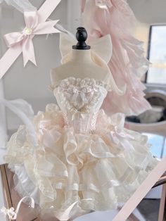 a dress made out of fabric and ribbon