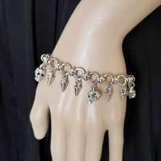 "This metal skull and spike charm bracelet is sure to add a touch of badass style to your outfit. It would make an awesome gift for any punk rock or biker babe!! 💀 DESCRIPTION: This silver metal link bracelet features metal spikes and either 3 highly detailed 3-D skull charms or 3 Swarovski crystal skull charms (you pick the colors). The bracelet was finished with a lobster clasp. This bracelet can also be made with only the spike charms. Choose the style from the drop down menu. 💀 STYLES: - A Gift For Doctor, Spike Bracelet, Biker Babe, Crow Skull, Metal Skull, Metal Spikes, Biker Jewelry, Badass Style, Gothic Punk