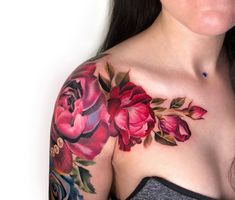 a woman's chest with flowers on it, and the top part of her arm