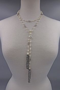 "- A trend-right lariat necklace with tassels that are hand wired with cultured pearls and crystals, unique designed necklace with extensive workmanship. Free shipping/domestic USA. - Total Length: 50\"L. Necklace length: 47\".Tassel Length: 3\"L. - Beads:Cultured fresh water pearls; rice shape: 6-7mm, potato shape: 8-9mm. Crystal beads; Faceted 4x6mm in black diamond and white opalite. - Style:Cultured pearl wire wrapping lariat choker tassel necklace. - Premier quality wire that does not tarni Elegant Lariat Beaded Necklace For Layering, Handmade Pearl Lariat Necklace, White Beaded Lariat Necklace, Pearl Lariat Necklace For Party, Adjustable Pearl Lariat Backdrop Necklace, Handmade Lariat Tassel Necklace, Beaded Chain Lariat Necklace For Party, Adjustable Pearl Chain Lariat Necklace For Party, Beaded Lariat Tassel Necklace