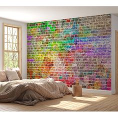 a bedroom with a large brick wall in the background and lots of pillows on the bed