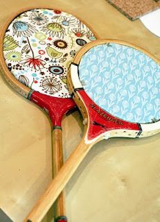 two tennis rackets sitting on top of a wooden table