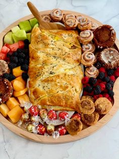 a wooden plate topped with lots of different types of food