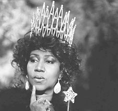 a black and white photo of a woman wearing a tiara with the word happy written on it