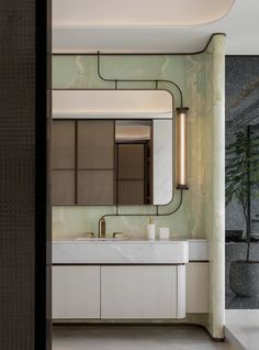 a bathroom with a large mirror and two sinks on the wall next to each other