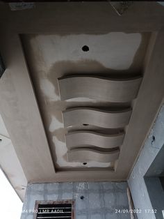 an unfinished ceiling in the middle of a building under construction, with plaster on it