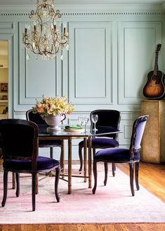 a dining room with blue walls and chairs